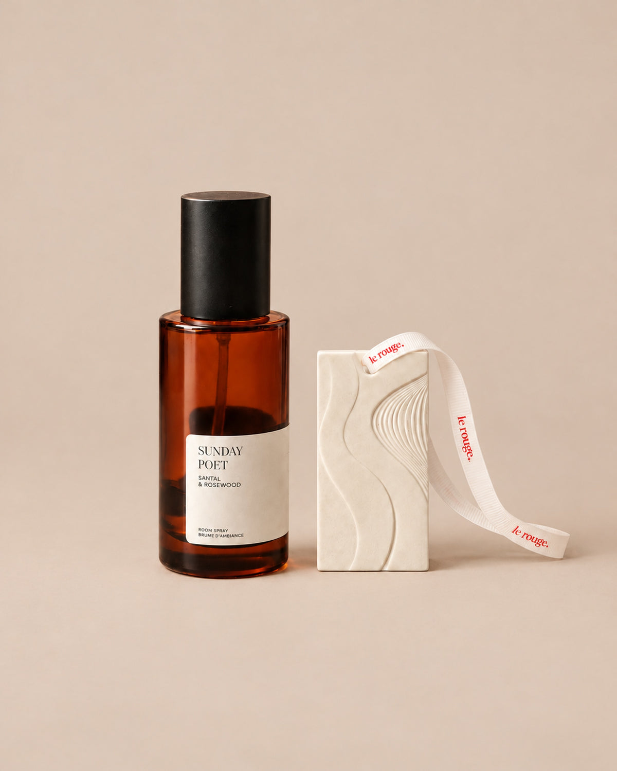 Sunday Poet room spray and WAVE ornament duo on a plain beige background