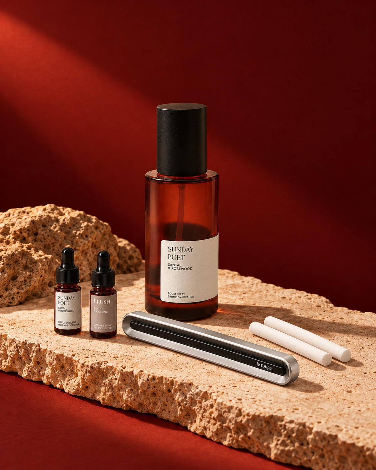 Home and Drive gift set with Sunday Poet room spray and complete LuxeDrive set styled on stone with a red backdrop