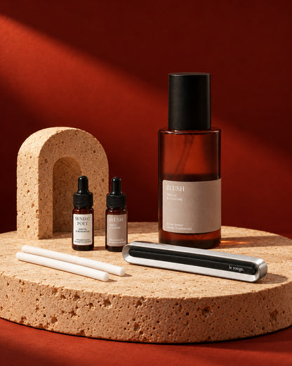 Home and Drive gift set with Blush room spray and complete LuxeDrive set styled on stone with a red backdrop