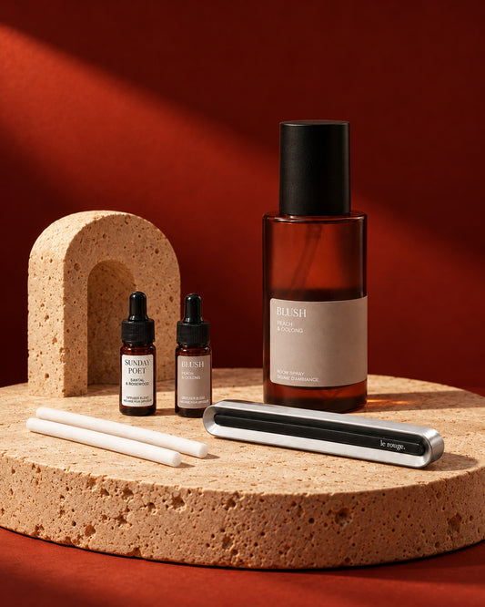 Home and Drive gift set with Blush room spray and complete LuxeDrive set styled on stone with a red backdrop