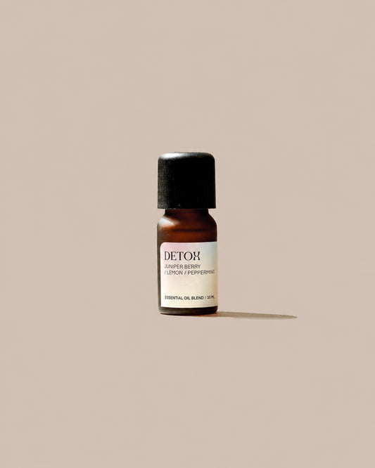 DETOX Essential Oil Blend 10ml with pale patterned label on a clean beige background.
