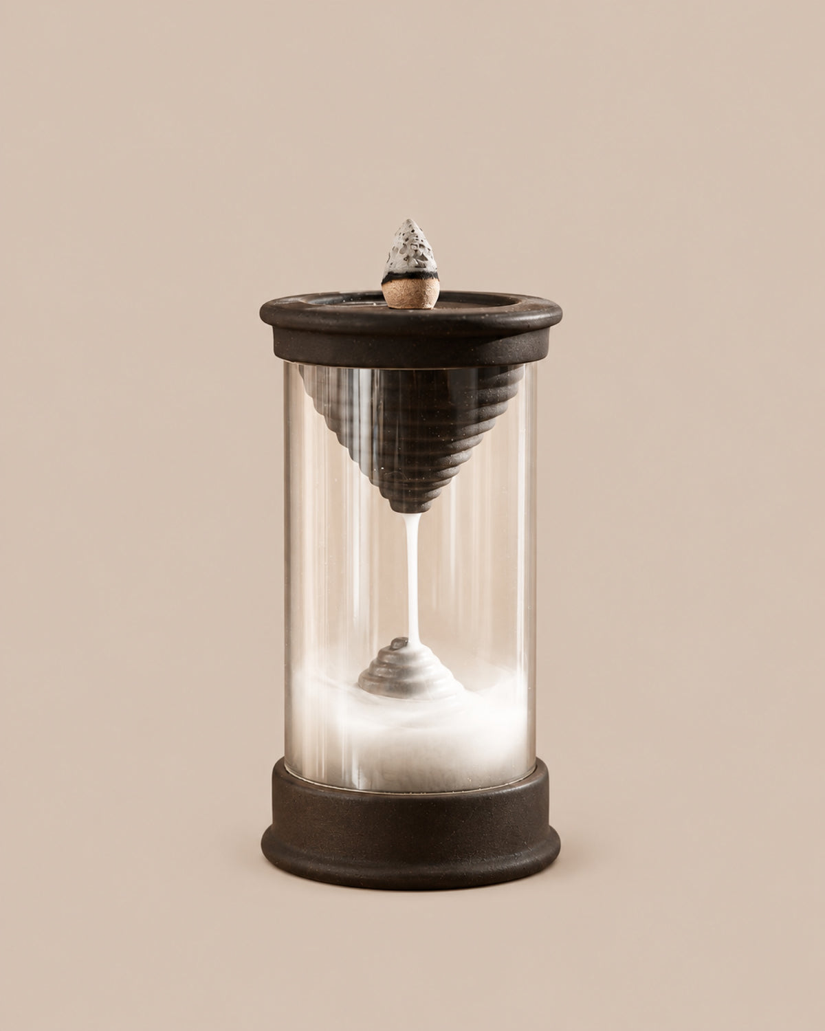 Handmade dark brown Hourglass backflow incense burner with a clear chamber showing a downward stream of smoke, on a beige background.